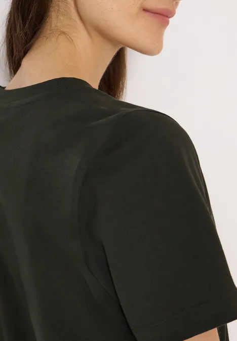 Gedeeltelijke weergave van een persoon in een donker T-shirt, rug en kin in profiel.