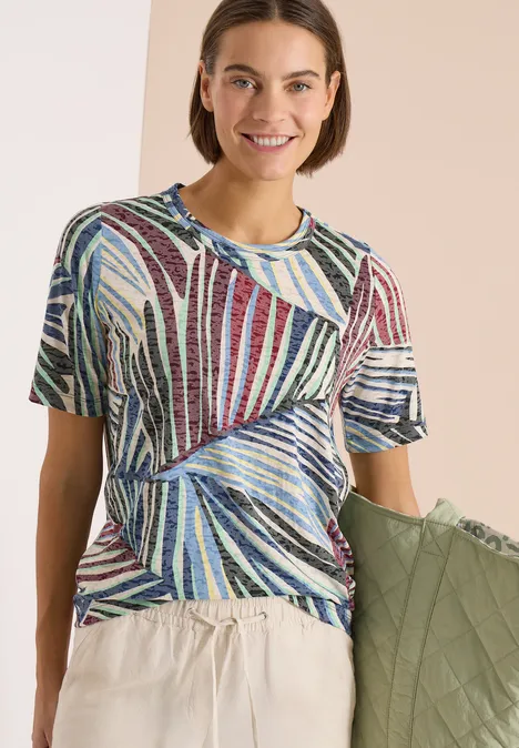 Personne portant un t-shirt rayé coloré et un pantalon beige