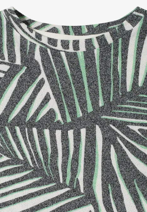 Mouwloze glittertop in zilver met groen palmbladprint.