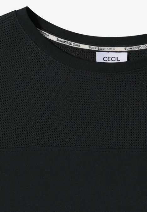Zwart damesshirt met meshstuk boven de borst en "CECIL" label in de nek.