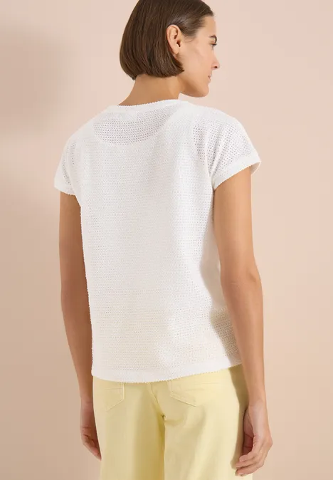 T-Shirt mit Boatneck im Ajour-Look vanilla white Frau von hinten in weißem T-Shirt und gelber Hose vor neutralem Hintergrund.