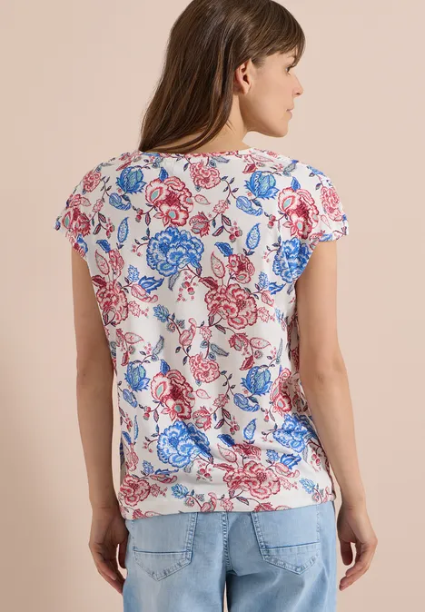 Kurzarm Shirt mit Boatneck und Raffung vanilla white Frau von hinten in weißem T-Shirt mit rotem und blauem Blumenmuster und Jeans.