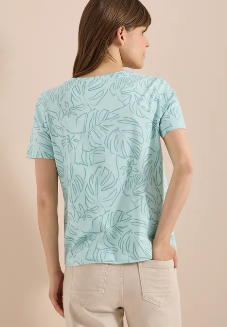 T-Shirt mit Rundhals und Blätterprint crystal mint Eine Frau von hinten in mintgrünem Blattmuster-Shirt und beiger Hose.