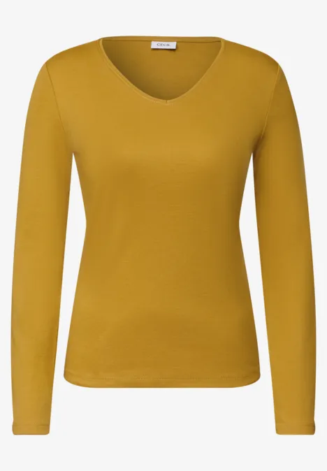Haut manches longues femme jaune moutarde à col en V en tissu doux.
