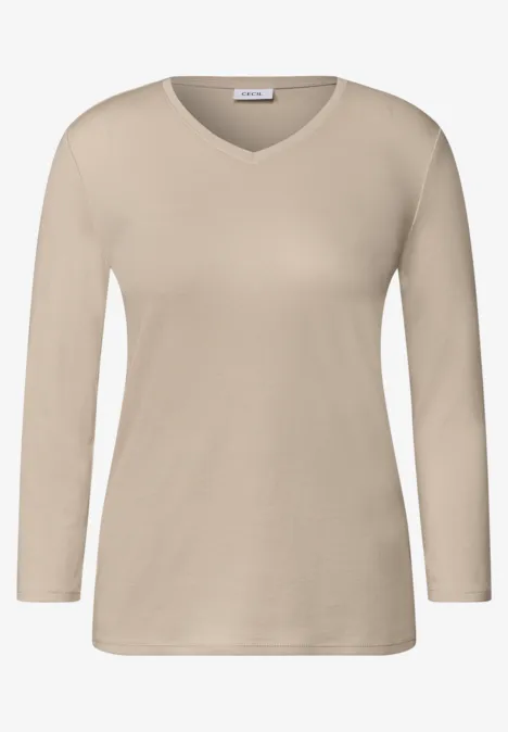 T-shirt à manches longues beige avec encolure en V.