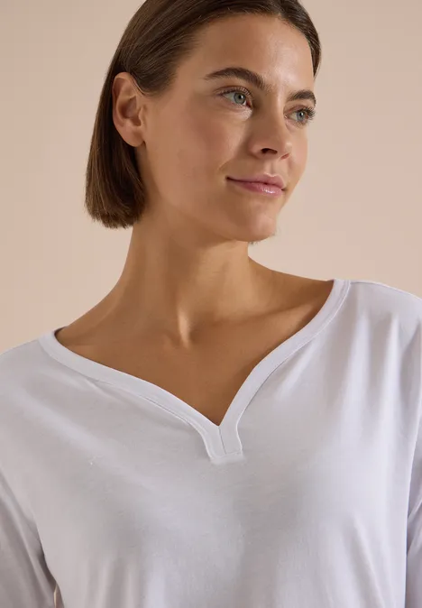 Shirt mit Split Neck im Tunika-Look White Portrait einer Frau mit kurzen braunen Haaren in einem weißen Shirt mit V-Ausschnitt.