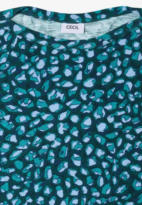Grünes T-Shirt mit abstraktem Muster aus hellblauen und türkisen Flecken.