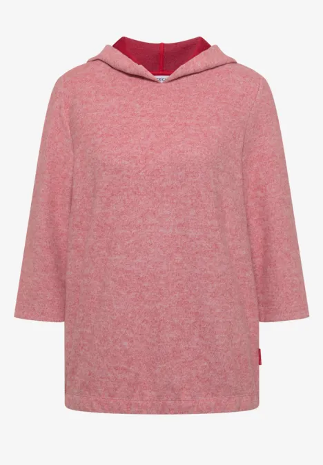 Pull à capuche rose ample, manches 3/4 et fentes latérales.