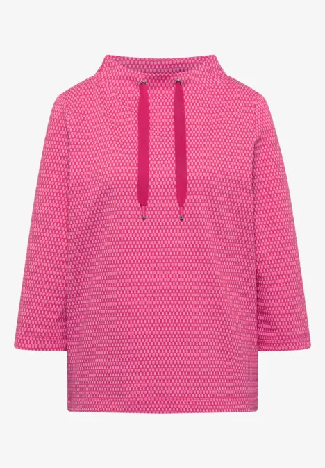 T-shirt à manches 3/4, col cheminée et texture pink flash Sweat à capuche rose à motif subtil avec cordons assortis.