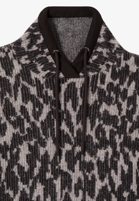 Grofgebreide hoodie met capuchon, koordjes en abstract zwart-wit patroon.