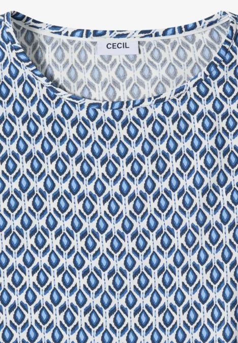 Mouwloos damestop in wit en blauw met ovaal patroon en ronde hals.