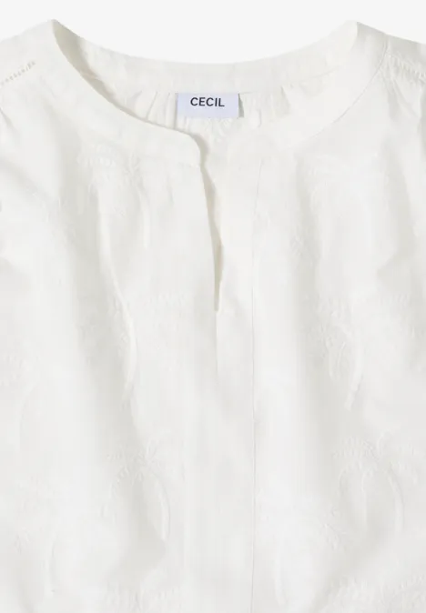 Wit mouwloos topje met ronde hals en fijne structuur.