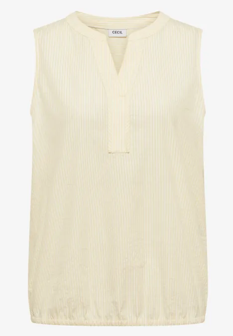 Top sans manches couleur crème, col en V et texture légère.