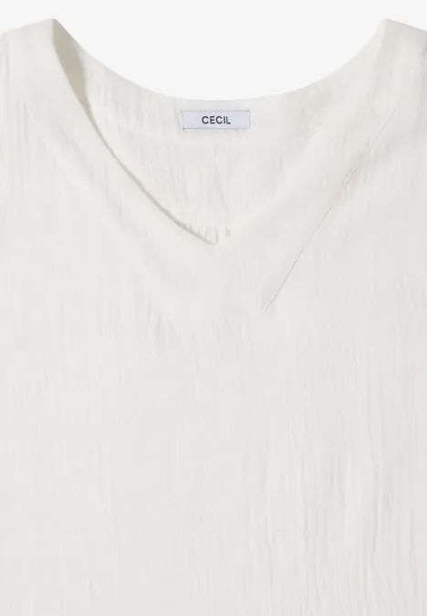 Weißes ärmelloses V-Neck-Top aus leicht strukturierter Baumwolle.