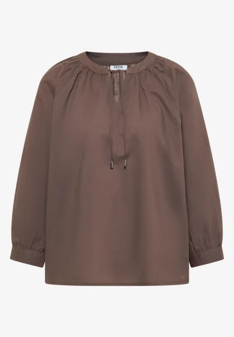 Braune Bluse mit langen Ärmeln und Bindeband am Ausschnitt.