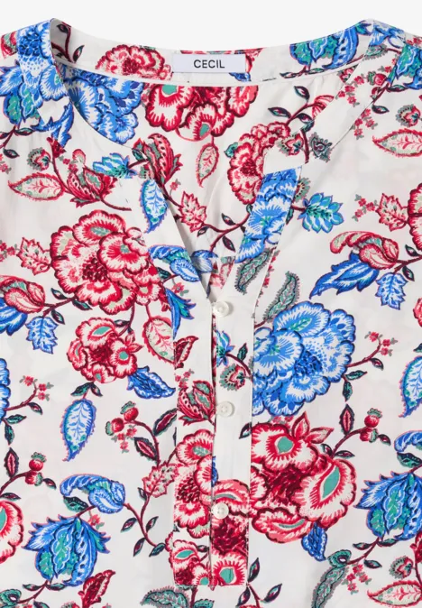 Licht damestop wit met rood-blauwe bloemenprint, V-hals met strikdetail.