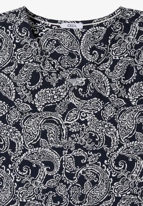Haut noir orné d'un imprimé paisley blanc et motifs floraux