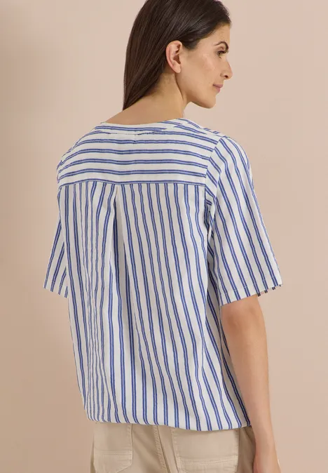 Halbarm Bluse mit Split Neck und Streifen deep river blue Frau von hinten in kurzärmeliger, blau-weißer, vertikal gestreifter Bluse vor hellem Hintergrund.