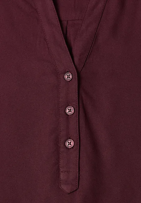 Bordeauxrotes Damen-Top mit V-Ausschnitt und drei passenden Knöpfen.