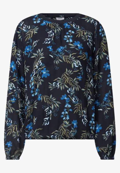 Schwarze Bluse mit langen Ärmeln und blau-grünem Blumenmuster.
