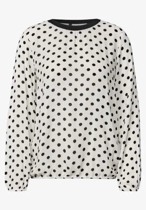 Weißes langärmliges Oberteil mit schwarzem Polka-Dots-Muster
