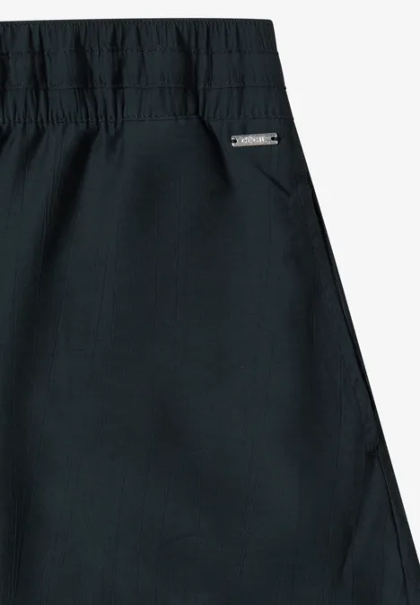 Zwart kledingstuk met elastische taille en zijzak met een klein label.