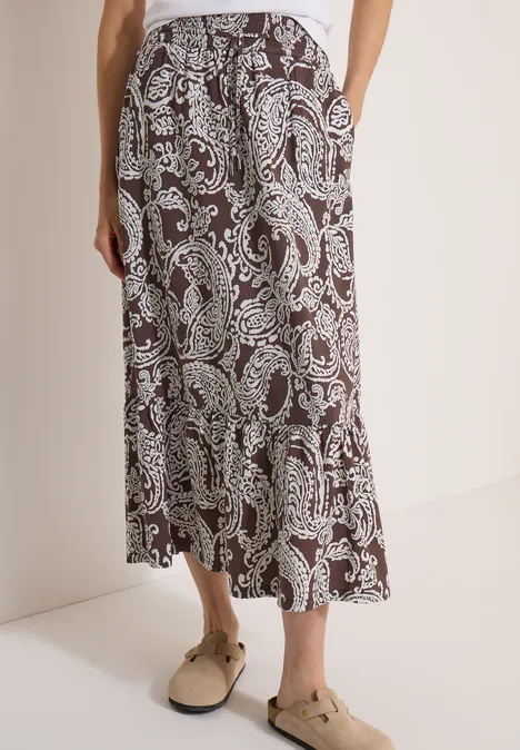 Jupe longue à motifs floraux brown cacao Jupe midi marron avec imprimé paisley blanc et poches latérales.