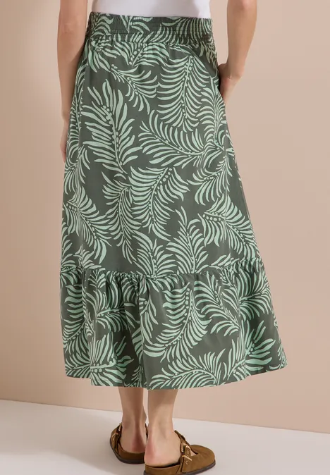 Maxirok met bladmotief khaki Groene midirok met tropisch bladpatroon, soepel vallend model met gerimpelde zoom.