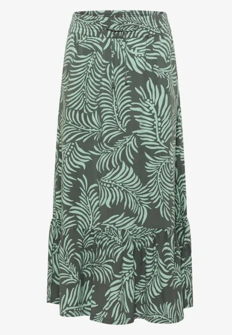 Maxirok met bladmotief khaki Lange rok met groen bladprint op donkere achtergrond en volantonderrand.