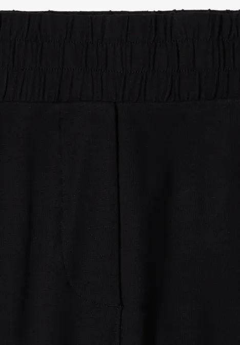 3/4 Wide Leg Hose im Casual Fit Black Schwarze Leggings mit hohem, elastischem Bund aus dehnbarem Jersey-Stoff.