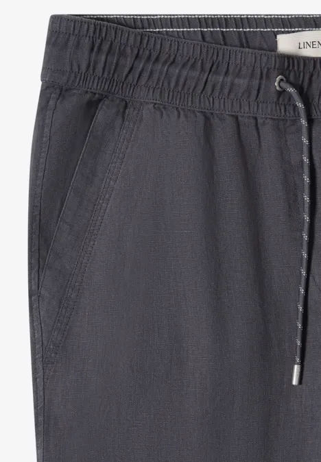 Donkergrijze joggingsbroek met elastische taille, trekkoord en zijzakken.