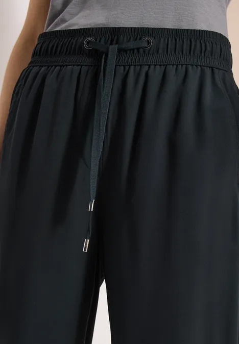 Pantalon de jogging noir avec taille élastique et cordon, en tissu fluide.