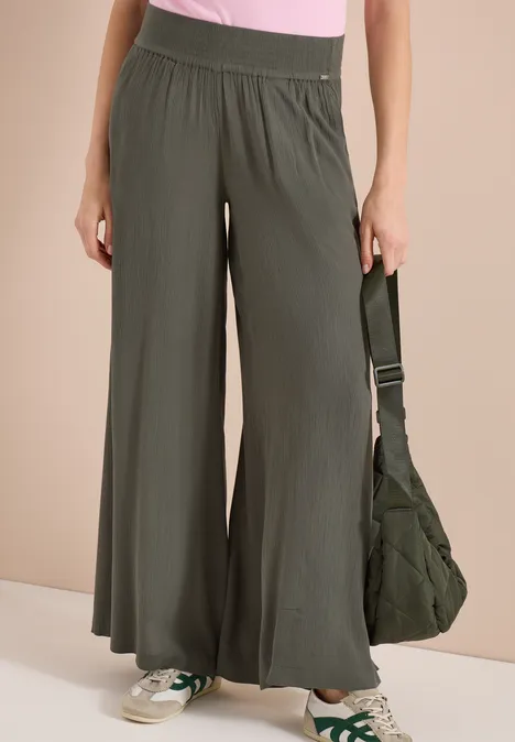 Pantalon femme ample vert olive à taille haute, style décontracté.