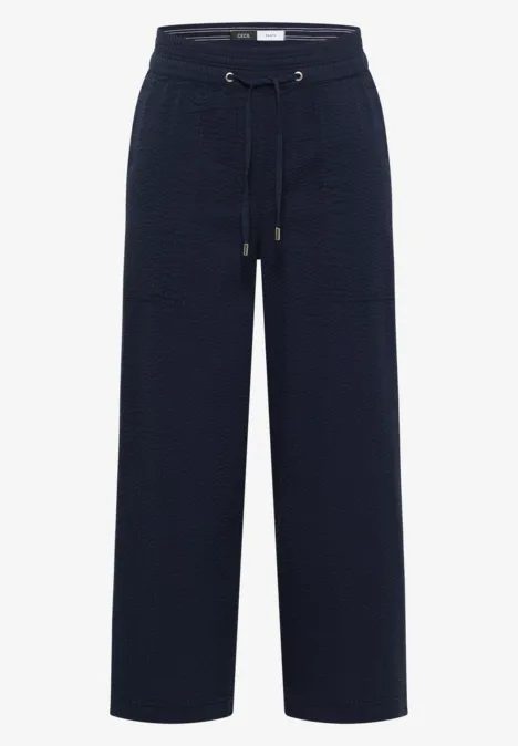 Dunkelblaue, weite Hose mit hohem Bund und Kordelzug, entspanntem Schnitt und großen Taschen.