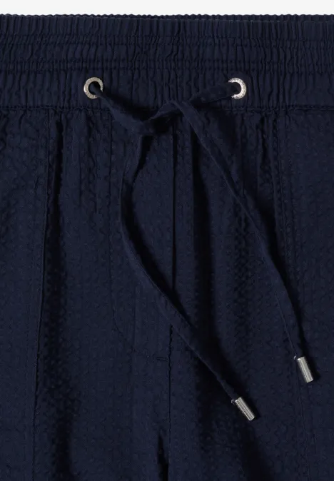 Navyblaue Sweatpantshose mit elastischem Bund, Kordelzug und strukturierter Strickoptik.