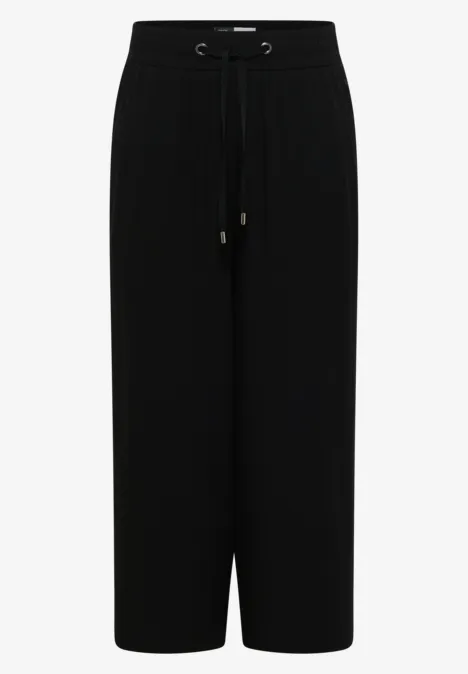 Pantalon noir ample à cordon de serrage, coupe droite et longueur cheville.