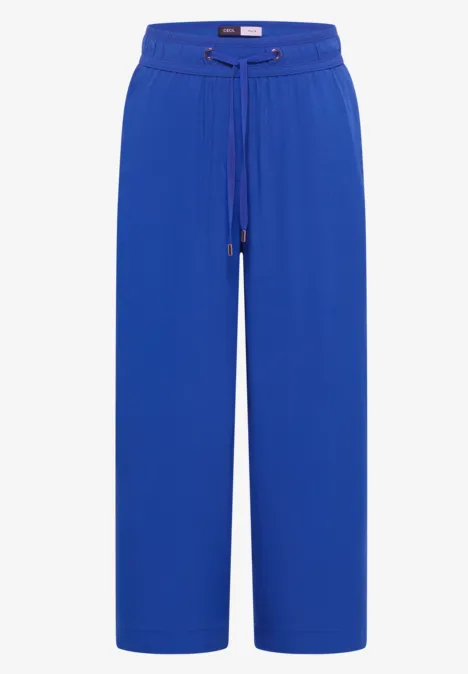 Weite blaue Damenhose mit hohem Bund und Kordelzug.
