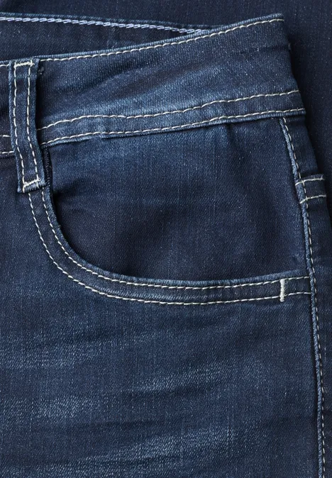 Nahaufnahme einer dunkelblauen Jeans-Tasche mit weißer Kontrastnaht.