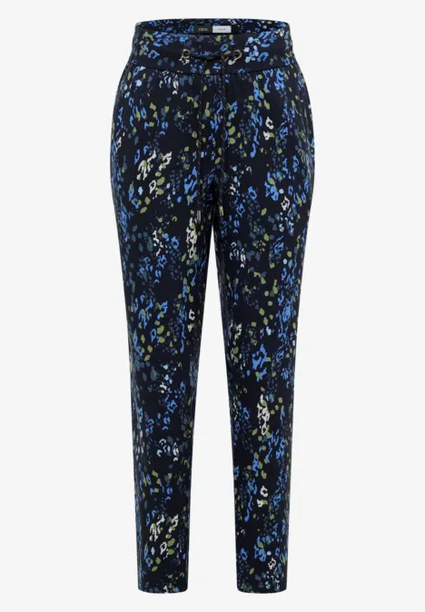 Pantalon femme à jambe droite, fond noir avec motif floral abstrait bleu-vert.