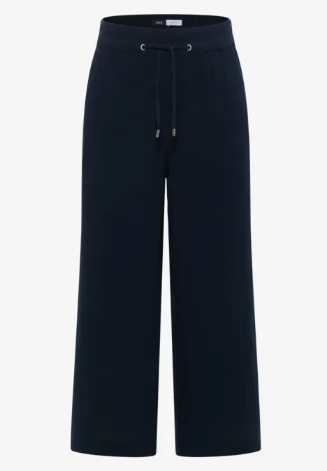 Pantalon noir ample à taille élastique avec cordon et coupe droite.