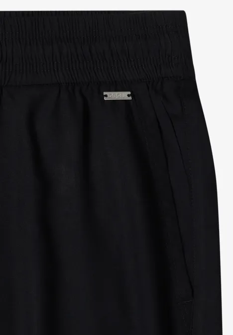 Schwarze, hoch taillierte Hose mit Gummibund und seitlichen Nahttaschen aus weichem Jerseystoff.