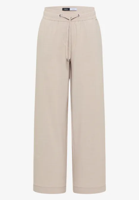 Pantalon de jogging beige ample à jambes larges, ceinture à cordon de serrage.