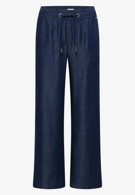Dunkelblaue, weite Jeanshose mit elastischem Bund und Kordelzug.