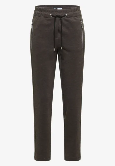 Pantalon de jogging brun foncé avec cordon de serrage et poches zippées.