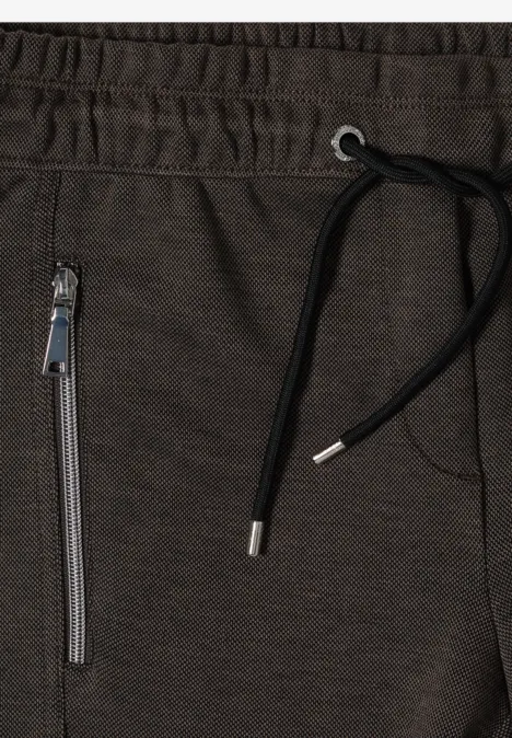Jogging gris foncé avec taille élastique, cordon noir et poche latérale zippée argentée.