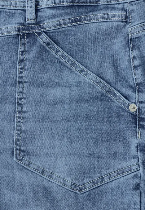 Jean taille mi-haute à Barrel Leg, coupe décontractée mid blue wash Gros plan d’une poche de jean bleu avec coutures apparentes et rivet métallique.