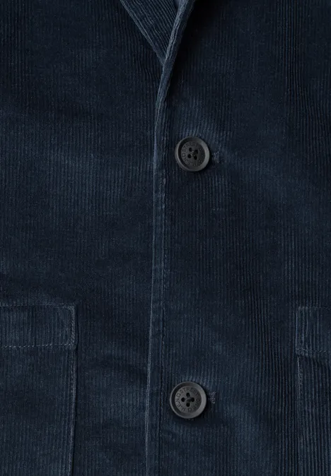 Blazer en velours côtelé bleu foncé avec deux boutons et poches plaquées.