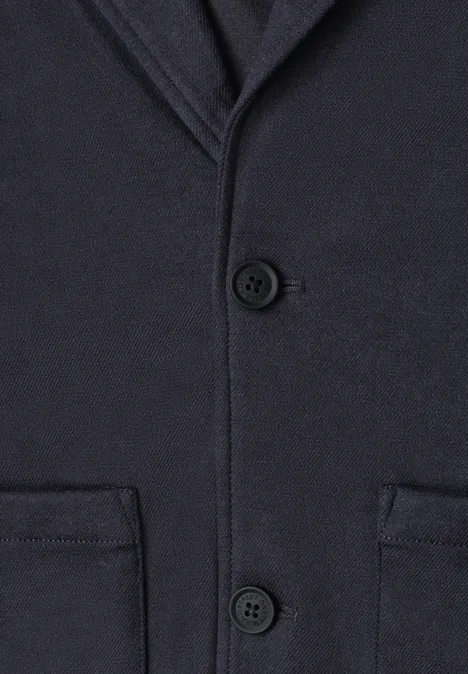 Dunkelblauer Wollmantel mit Knöpfen und aufgesetzten Taschen.