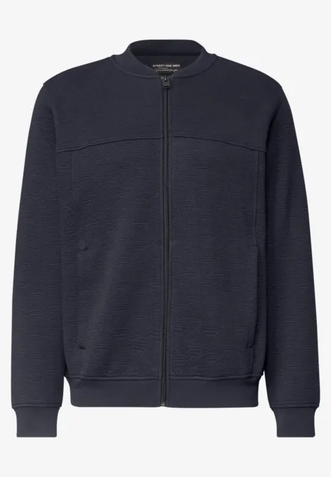 Blouson bomber bleu marine à fermeture éclair, poches latérales et finitions côtelées.