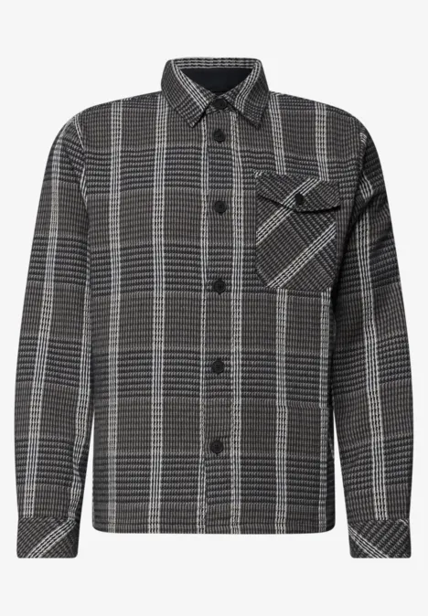 Chemise à carreaux noire et blanche, manches longues, poche poitrine et coupe droite décontractée.